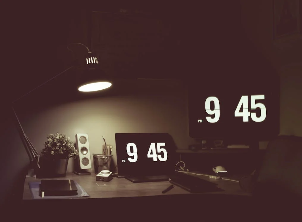 Workstation with digital clocks displaying 9:45, representing time management